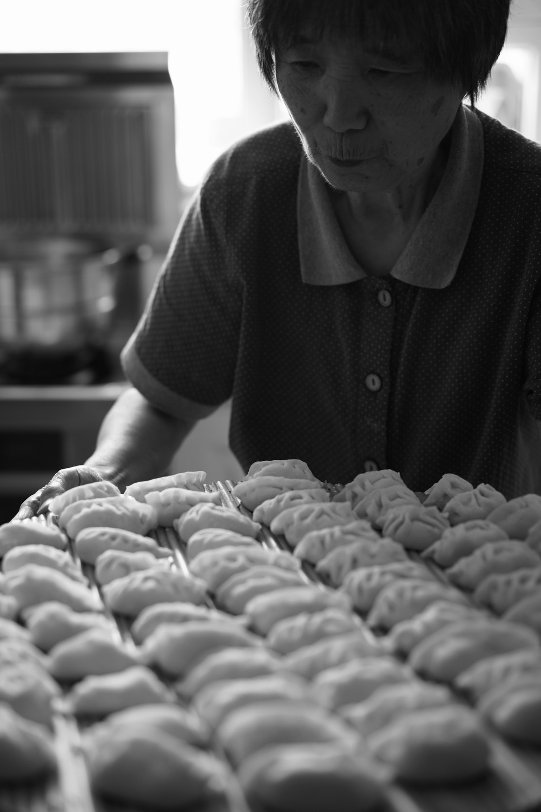 A black and white portrait at a food market.